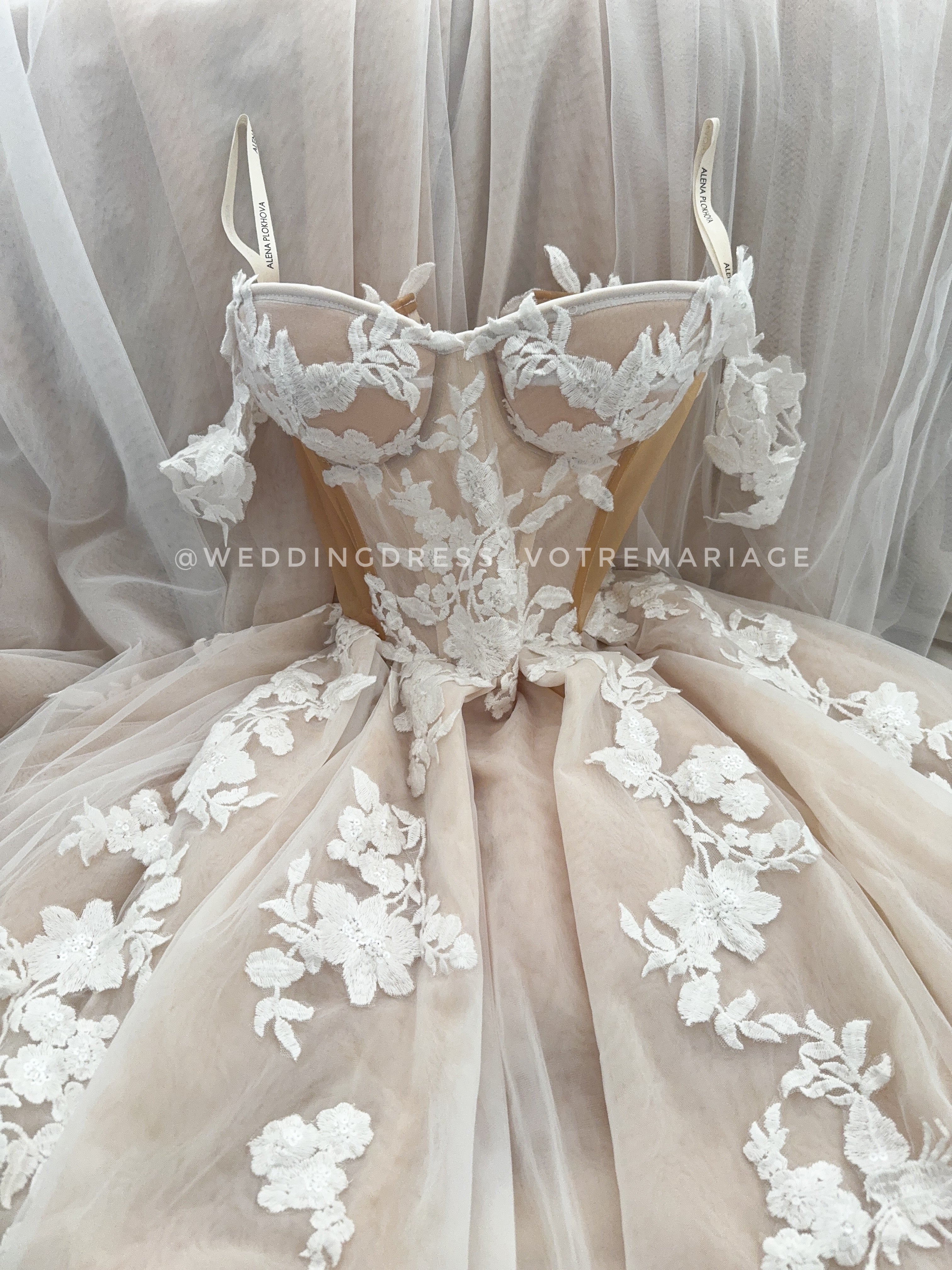 corset insert for wedding dress An A-line gown with a skirt slit. Crafted from textured lace with a delicate, airy pattern. The corset has a sheer insert and is lightly embellished with transparent crystals along the neckline., The