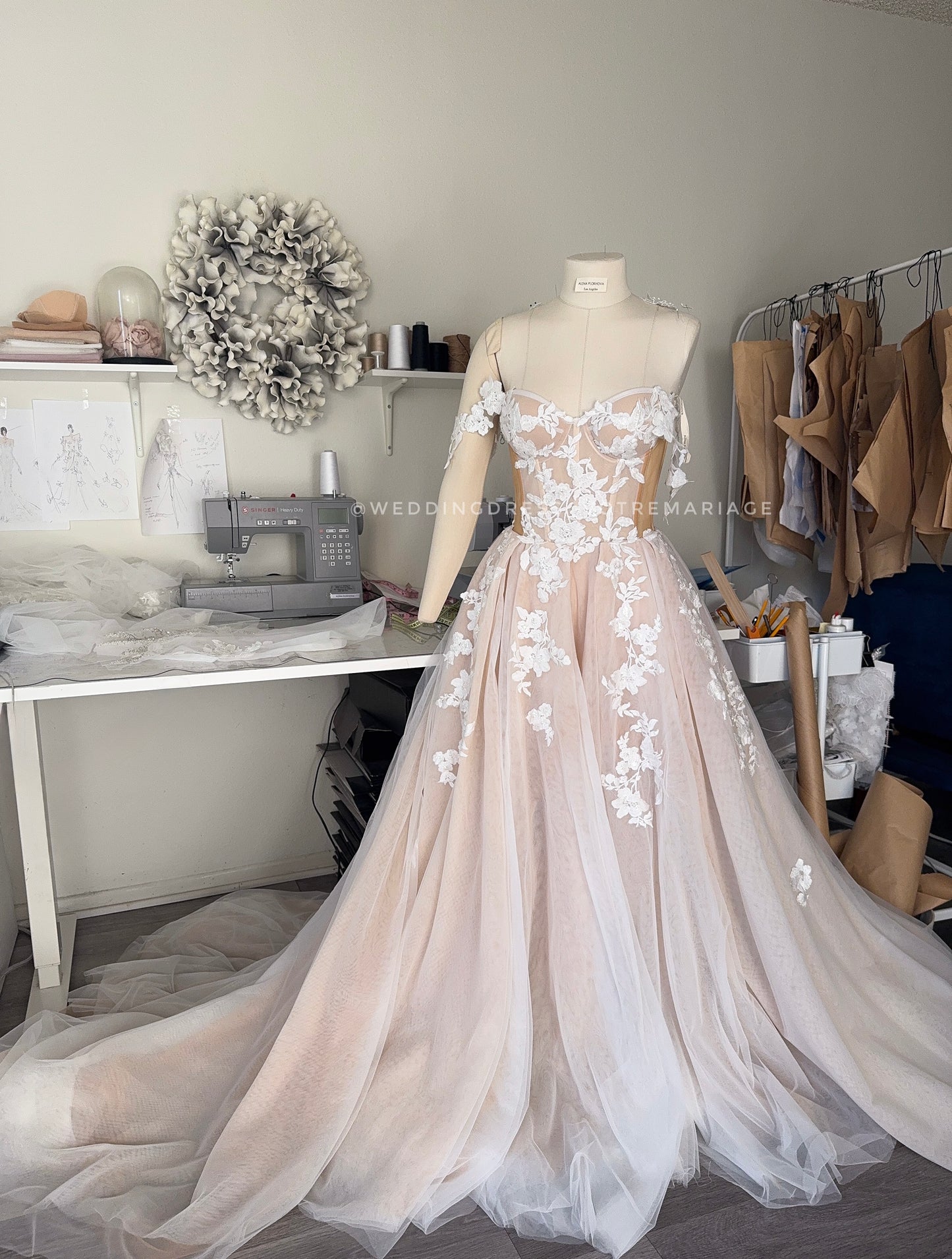 Athina/ Blush wedding dress with sheer inserts on the corset.