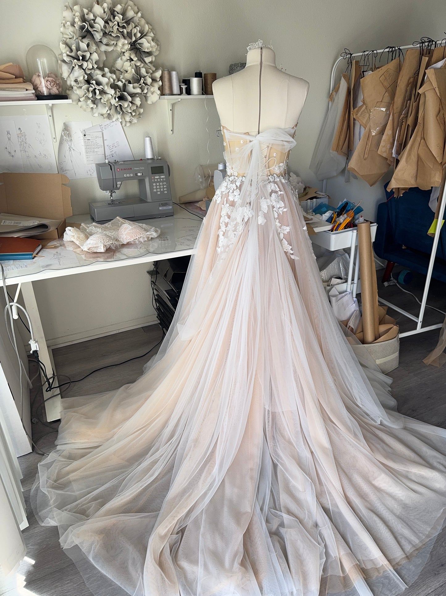 Chloe / Corset A-line wedding dress in blush color with a train.